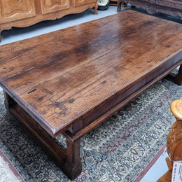 Impressive large size rustic French Oak coffee table with two drawers on a stretcher base. In good original detailed condition and sourced from France.