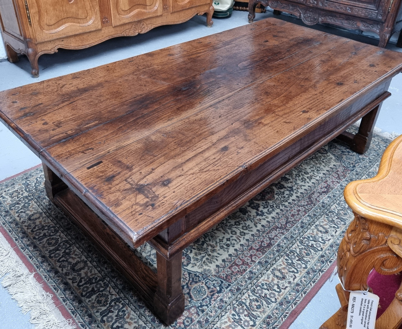 Impressive large size rustic French Oak coffee table with two drawers on a stretcher base. In good original detailed condition and sourced from France.