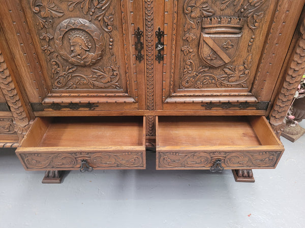 Large French Oak Renaissance style four door sideboard/buffet. Great decorative item with amazing carvings and stunning iron work on base. It is in good original detailed condition. Can pull apart completely making it easier to move.