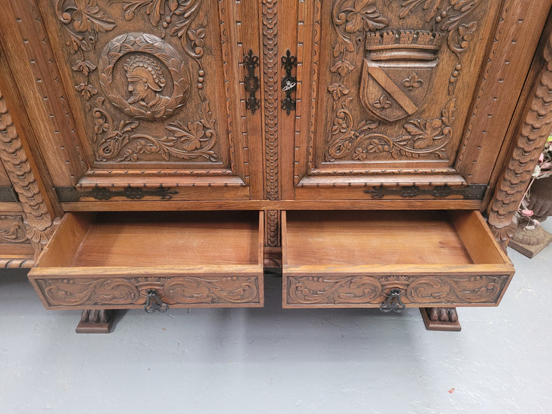 Large French Oak Renaissance style four door sideboard/buffet. Great decorative item with amazing carvings and stunning iron work on base. It is in good original detailed condition. Can pull apart completely making it easier to move.
