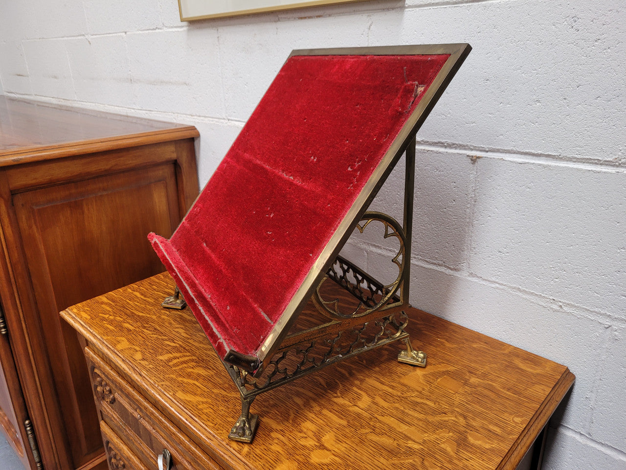Antique French brass Gothic Revival book stand with red velvet. It has sourced from France and is in good original condition.