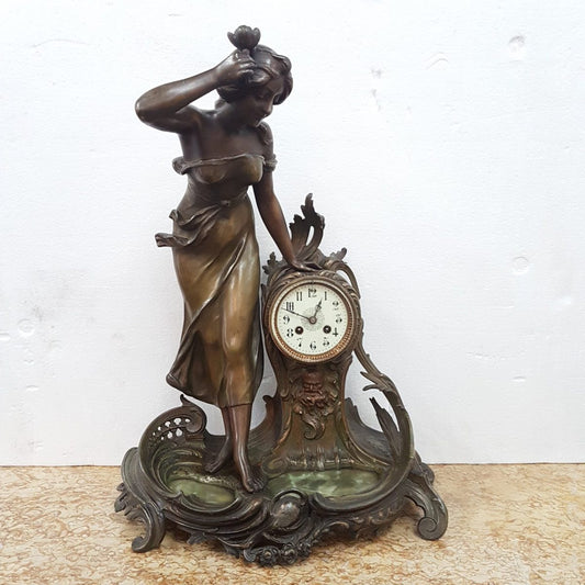 An elegant French Art Nouveau figural clock, with onyx marble depicting water and constructed from spelter. The clock is 61cm high and is in good original condition and in working order.