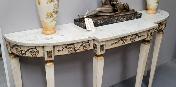 French Louis XVI style painted marble top console table. It is of pleasing narrow proportions and has been sourced from France. It is in good original detailed condition.