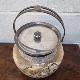 Royal Doulton Biscuit Barrel with silver plated top, handle and lid. Displaying a Daffodil pattern. In original condition please view photo's as they form part of the description.