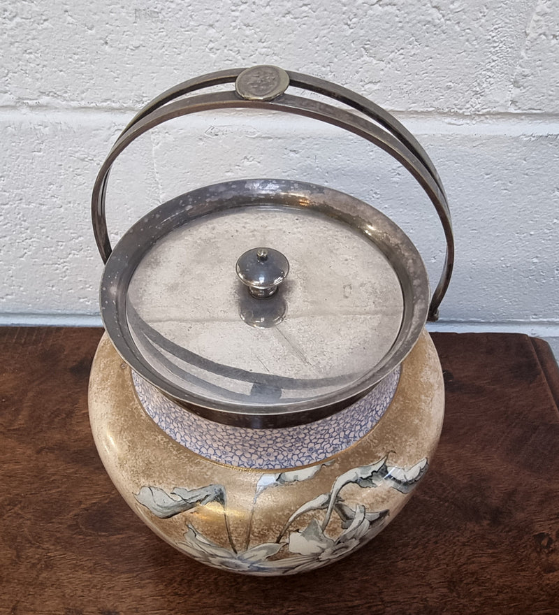 Royal Doulton Biscuit Barrel with silver plated top, handle and lid. Displaying a Daffodil pattern. In original condition please view photo's as they form part of the description.