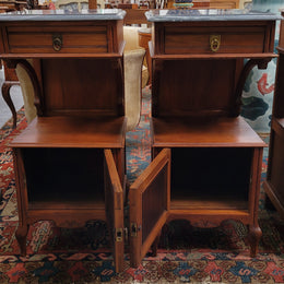 Pair of unusual transitional fruit wood marble top bedside cabinets. They have been sourced from France and are in good original detailed condition.