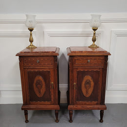 Pair of French Art Deco Oak and rouge inset marble top bedside cabinets. They have one drawer and one cupboard with elegant carving on the door. They have been sourced from France and are in good original detailed condition.
