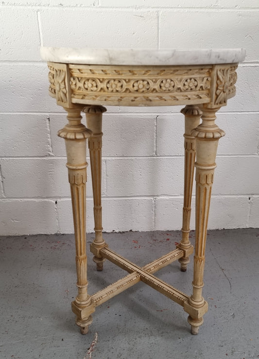 Louis XVI style round side table with original paint and a beautiful thick marble top. It is in good original detailed condition.