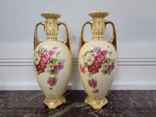 A beautiful pair of Edwardian Austrian hand-painted vases depicting a decorative flower scene. They are in good original condition with no chips or cracks. Please view photos as they help form part of the description.
