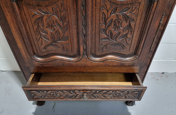 An Attractive French Louis XV style single-door ‘Marriage Armoire’. Beautifully arched crest with detailed carved flowers along with an arched single door which repeats the floral carvings. It is also has plenty of storage space with three adjustable shelves along with a drawer at the bottom. All in good original detailed condition.