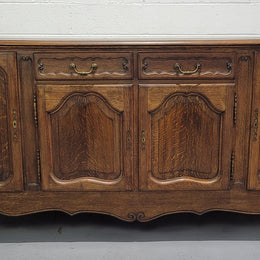 Late 19th Century French carved Oak Louis XV style four drawer sideboard. Plenty of storage space with four cupboards and two drawers. It is in good original detailed condition with all locks functioning with keys.