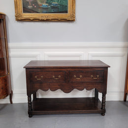 Rare size 19th Century English oak dresser base. It has two good size drawers and amazing patina. It has been sourced from France and in good original detailed condition.