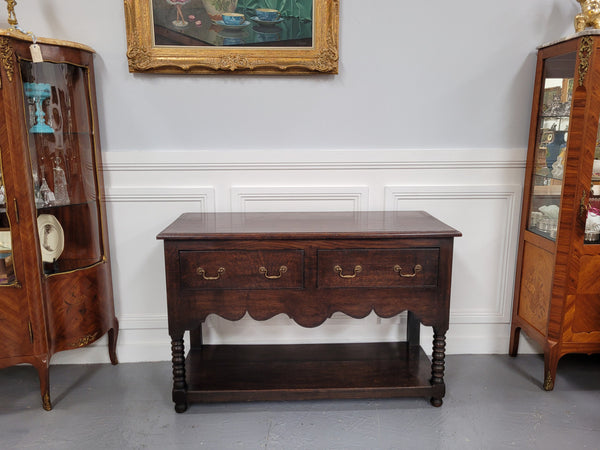 Rare size 19th Century English oak dresser base. It has two good size drawers and amazing patina. It has been sourced from France and in good original detailed condition.