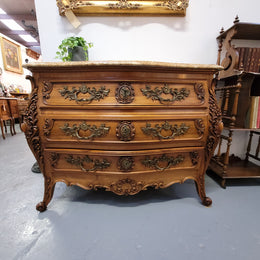 Impressive Louis XV style three drawer walnut commode. Ormolu handles and bevelled marble top complimenting detailed carving. In very good original detailed condition.