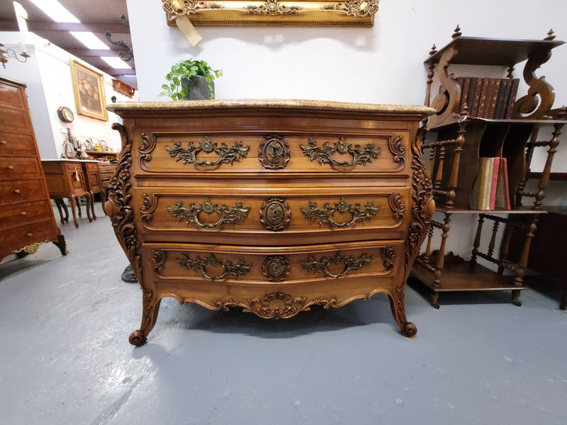 Impressive Louis XV style three drawer walnut commode. Ormolu handles and bevelled marble top complimenting detailed carving. In very good original detailed condition.