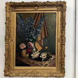 An Antique gilt-framed oil painting of floral still life. Housed in a double sweep gilt frame, signed and dated in good condition.