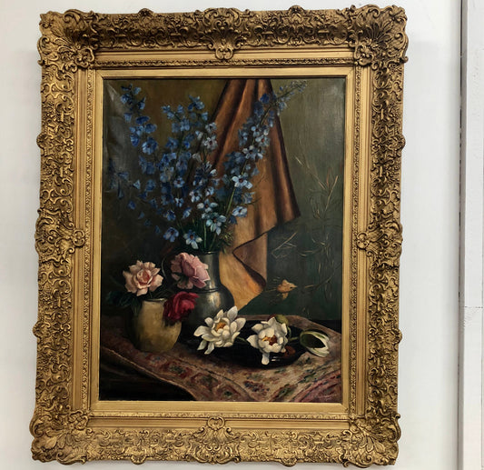 An Antique gilt-framed oil painting of floral still life. Housed in a double sweep gilt frame, signed and dated in good condition.