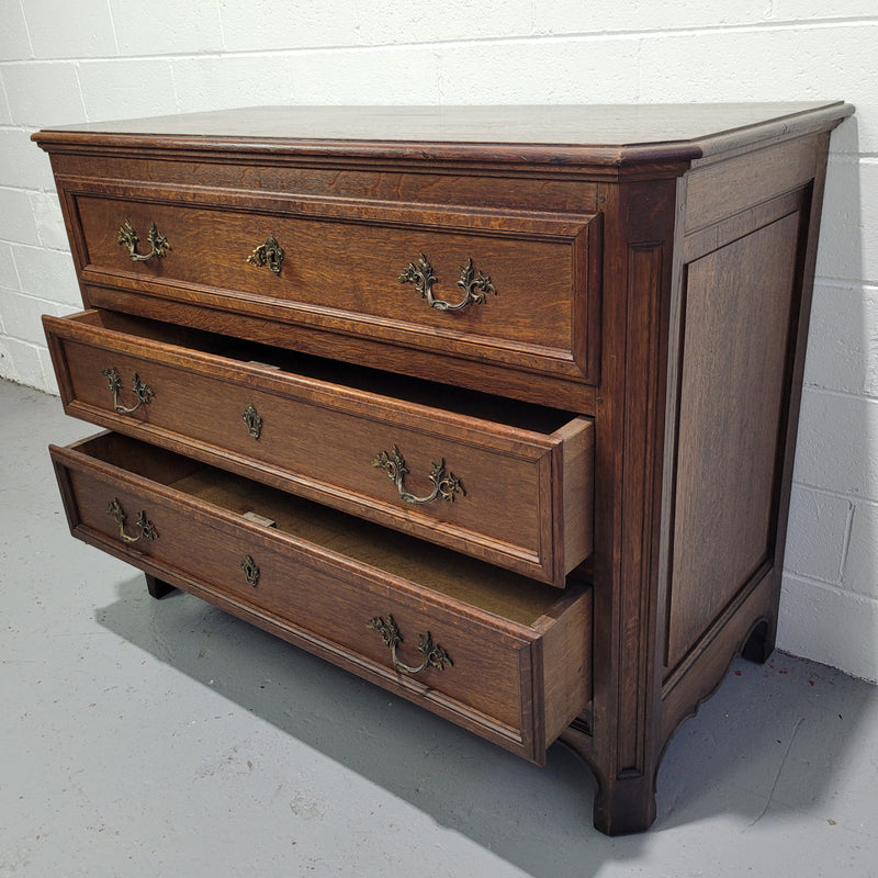 Solid Oak French 19th century three drawer commode, with decorative handles. In good original detailed condition.