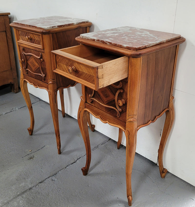 Pair French Walnut Louis XV style Bedside Cabinets with inset rouge carrera marble tops and parquetry inlay. Consisting of one drawer and one cupboard on very elegant legs. Circa: 1900's.