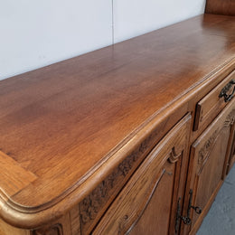 Lovely French Oak three-door sideboard with beautifully carved details and there is also a drawer. In good original detailed condition.