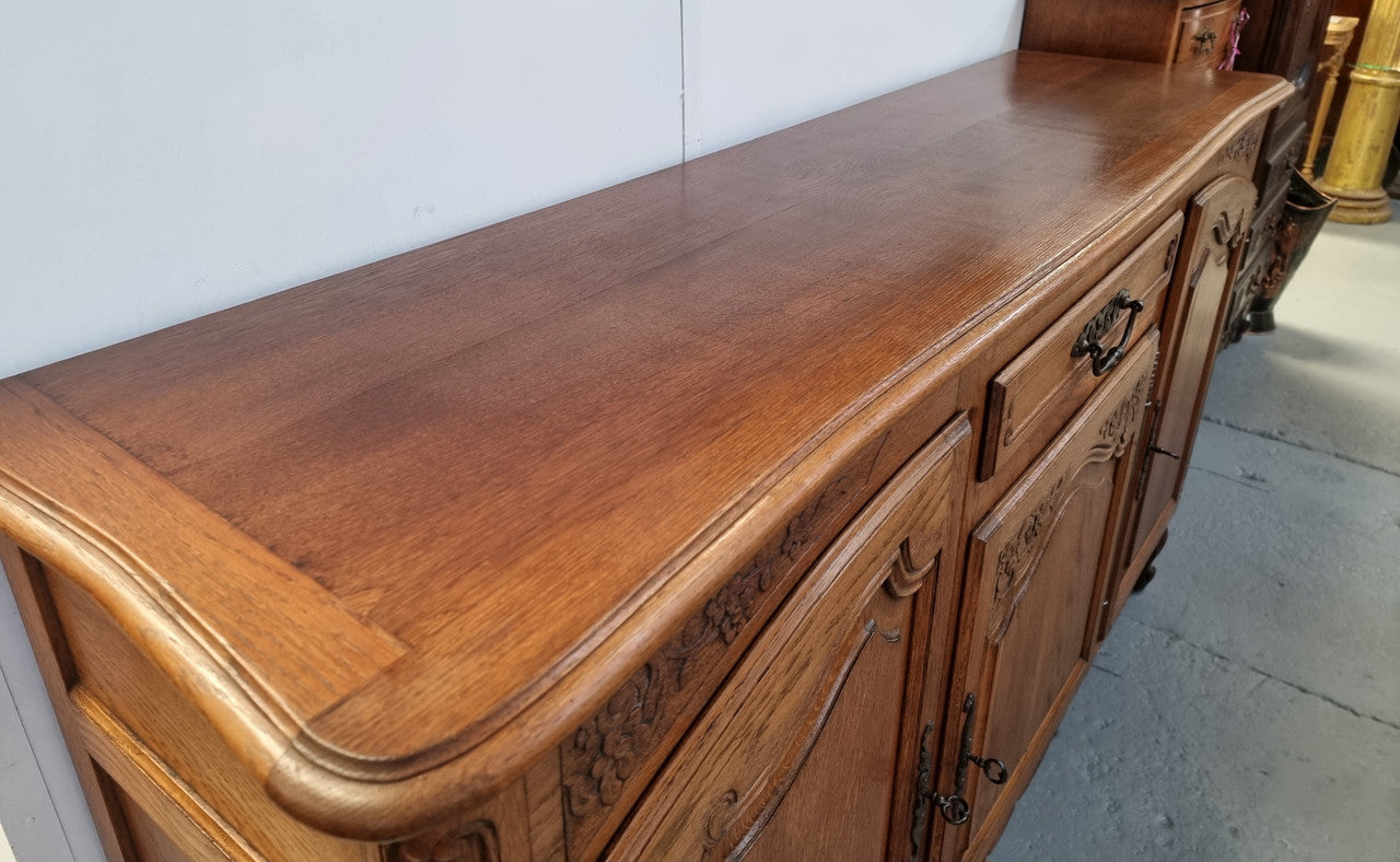 Lovely French Oak three-door sideboard with beautifully carved details and there is also a drawer. In good original detailed condition.