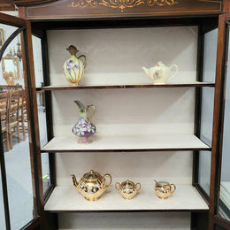Edwardian Sheraton style display cabinet with hand-painted panels and a good fabric interior. In good original detailed condition.