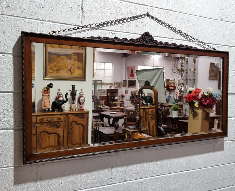 Attractive Edwardian rectangular wall mirror, with carved detail and beaded edge. Retaining it's original bevelled edge mirror and is in good original condition.