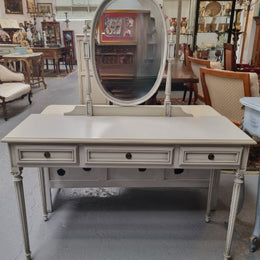 French Louis XVI style painted dresser / console with beveled oval mirror and three drawers. Sourced from France and in good original detailed condition.