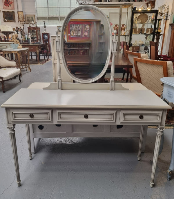 French Louis XVI style painted dresser / console with beveled oval mirror and three drawers. Sourced from France and in good original detailed condition.