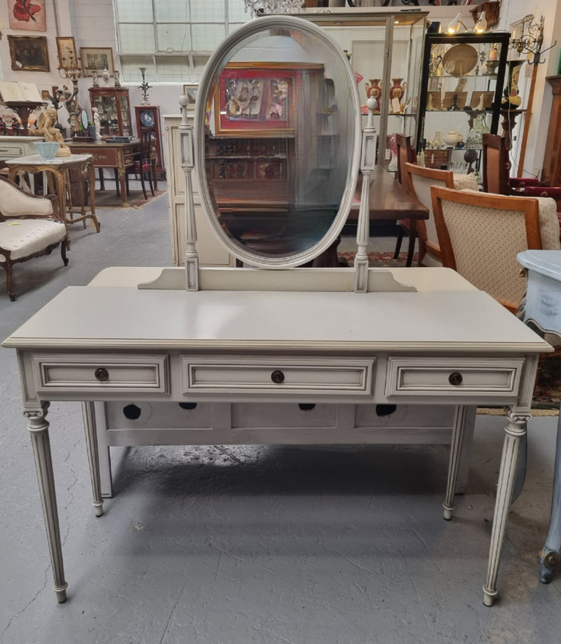 French Louis XVI style painted dresser / console with beveled oval mirror and three drawers. Sourced from France and in good original detailed condition.