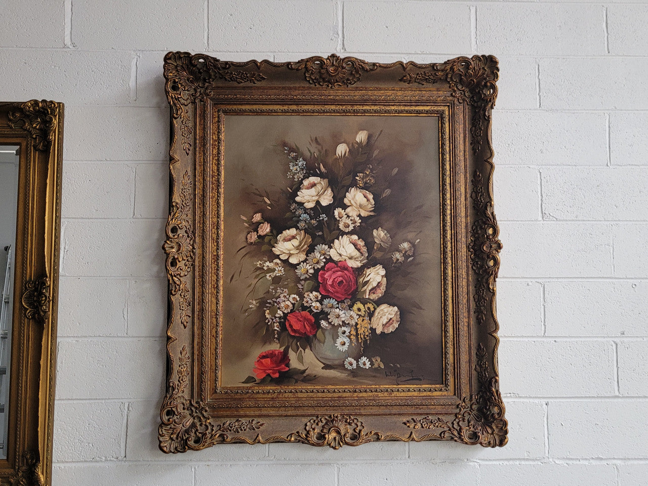 Attractive French floral oil on canvas - signed. Mounted in a stunning patterned gilded frame. It is in good original detailed condition.
