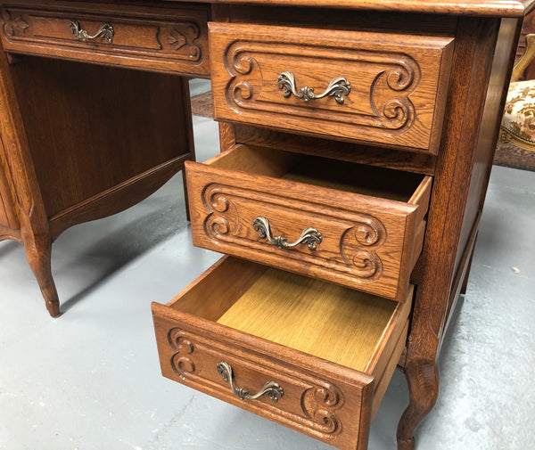 Beautifully carved French oak small desk with three drawers and a cupboard for all your storage needs. In good original condition. Great size for small spaces.