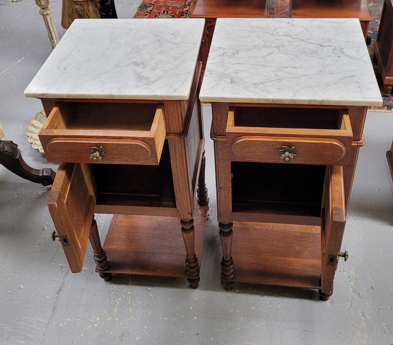 Antique French Oak Henry II white marble top bedside cabinets. They have one drawer and cupboard a long with an open shelf at the bottom. Sourced from France and in good original detailed condition.