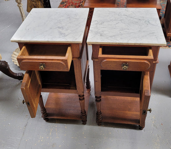 Antique French Oak Henry II white marble top bedside cabinets. They have one drawer and cupboard a long with an open shelf at the bottom. Sourced from France and in good original detailed condition.