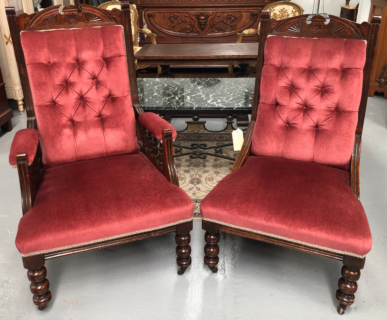 Beautiful pair of carved Edwardian arm chairs with lovely pink upholstery with button backs. In good condition.