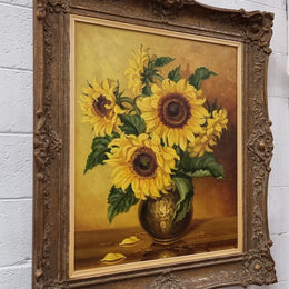 French signed oil on canvas depicting sunflowers in an attractive gilt frame. It is in good original detailed condition and has been sourced from France.