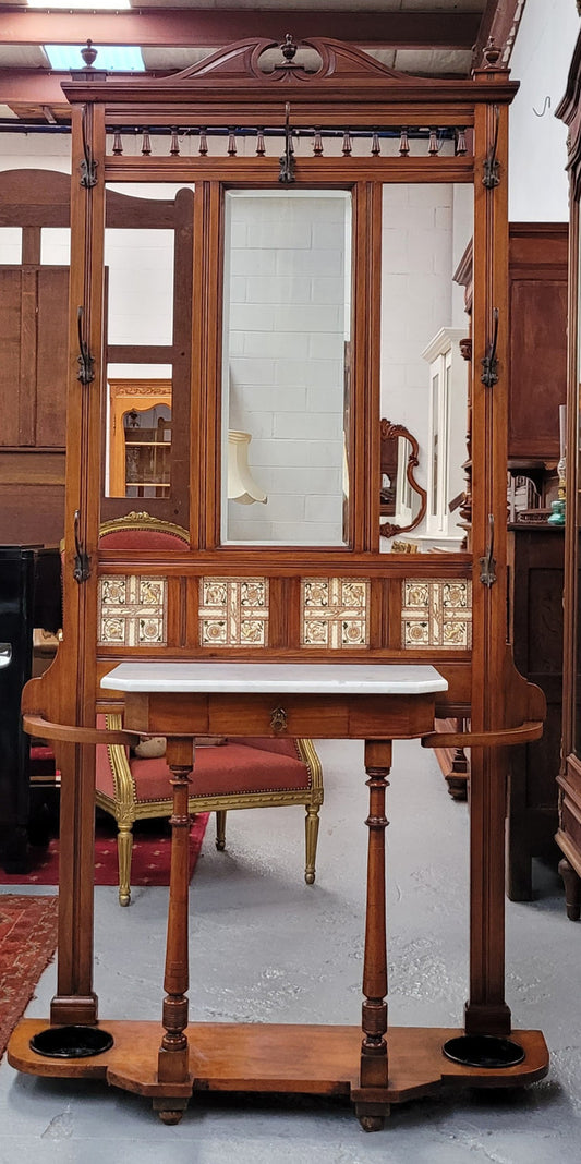 Late Victorian Arts and Crafts style marble top hall stand. Features three attractive tiles, original hooks and single drawer. In good original condition.