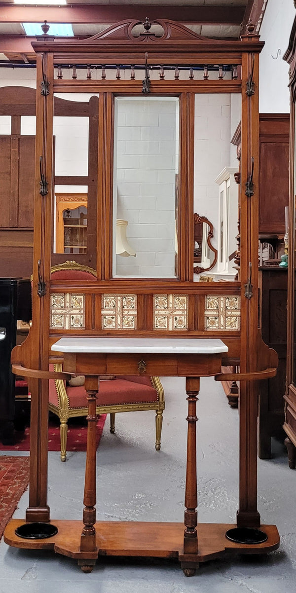 Late Victorian Arts and Crafts style marble top hall stand. Features three attractive tiles, original hooks and single drawer. In good original condition.