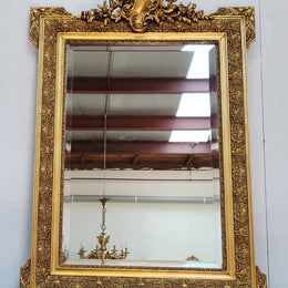 French 19th Century gilt over mantle mirror with beveled glass. In good original detailed condition.