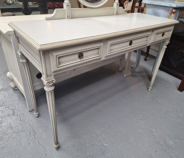 French Louis XVI style painted dresser / console with beveled oval mirror and three drawers. Sourced from France and in good original detailed condition.