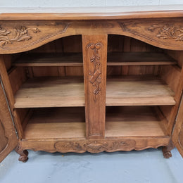 Parquetry top French oak Louis XV style sideboard with two draws and four cupboards. In good original detailed condition.