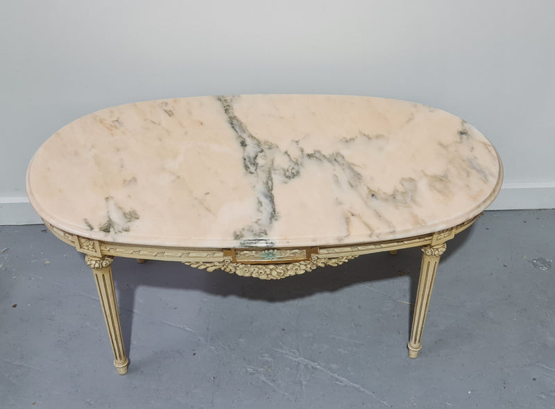 Charming painted Louis XVI style oval marble top coffee table. In good original detailed condition.