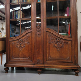 Substantial French Oak Louis 15th Style large two door bookcase. Adjustable shelves and very decorative carving. In good original detailed condition.