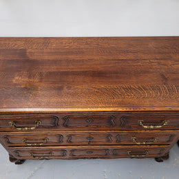 French Provincial Oak three drawer wooden top commode. It has elegant carvings and handles. It has been sourced from France and is in good original detailed condition.