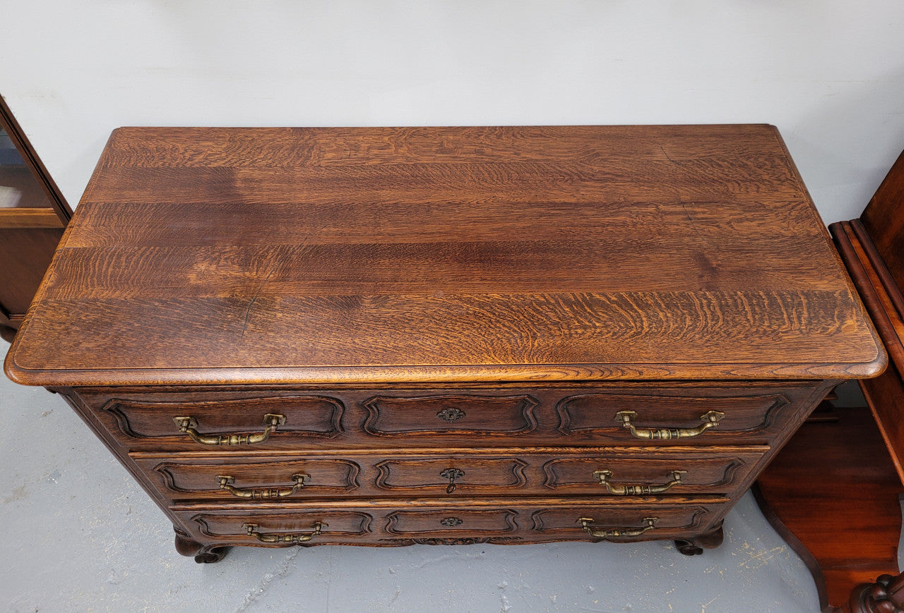 French Provincial Oak three drawer wooden top commode. It has elegant carvings and handles. It has been sourced from France and is in good original detailed condition.