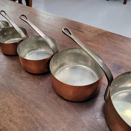 Set of five copper sauce pans with foundry stamp. They have been sourced from France and are in good original detailed condition.