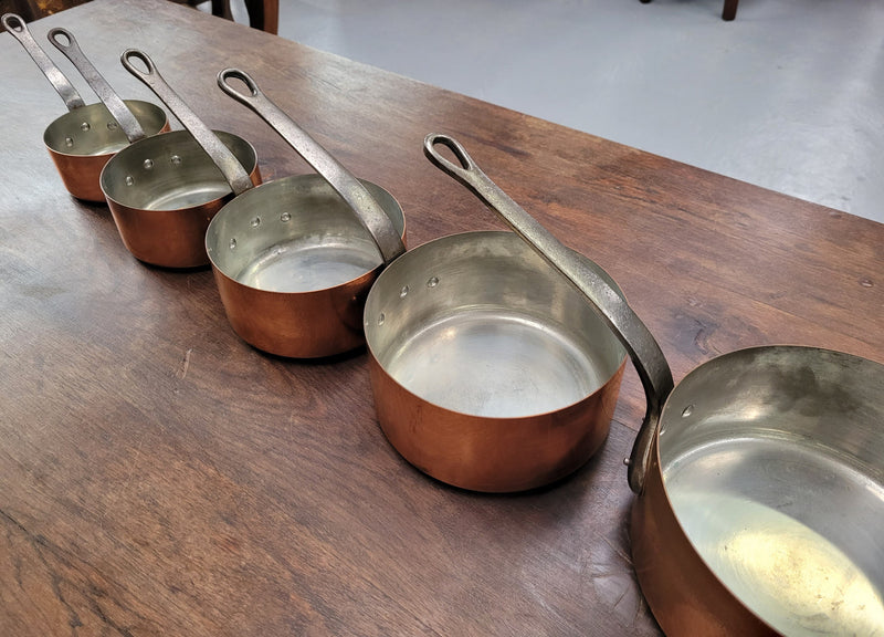Set of five copper sauce pans with foundry stamp. They have been sourced from France and are in good original detailed condition.