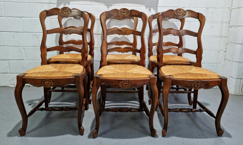 Set of six French Cherrywood rush seat dining chairs. In good restored condition.