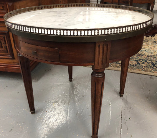 Large French Bouillotte table with a marble top and brass fitted gallery. It has two concealed leather - topped slides and two drawers and in good original condition.