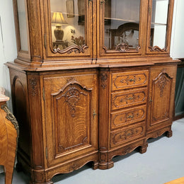 Impressive French Oak Louis 14th Style Display and Sideboard. It has 4 drawers, 2 bottom cupboards with 6 total shelves and 3 display doors with 3 shelves.  In good, detailed condition.